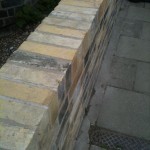 New brickwork of reclaimed bricks, making a garden wall
