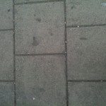 Square pavement flagstones, in 1-2-1 hopscotch pattern