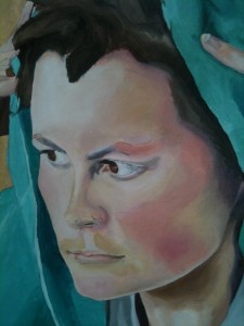 Picture of face framed by green cloth, showing some depth of colour and some depth of form, with not enough of either.