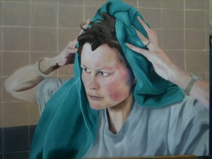 Portrait of artist drying her hair with green cloth.