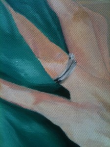 Close-up of metallic ring made with different shades of grey and a a little ochre.