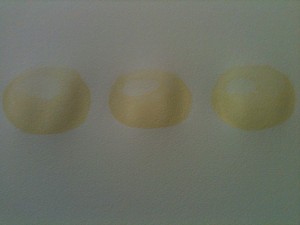 Three pale yellow forms with some moulding. They look like the ghosts of oranges.